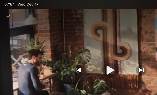 Scott Hunter from Heated Rivalry is seated in front of art that has a similar design to Dropout’s Game Changer set. 